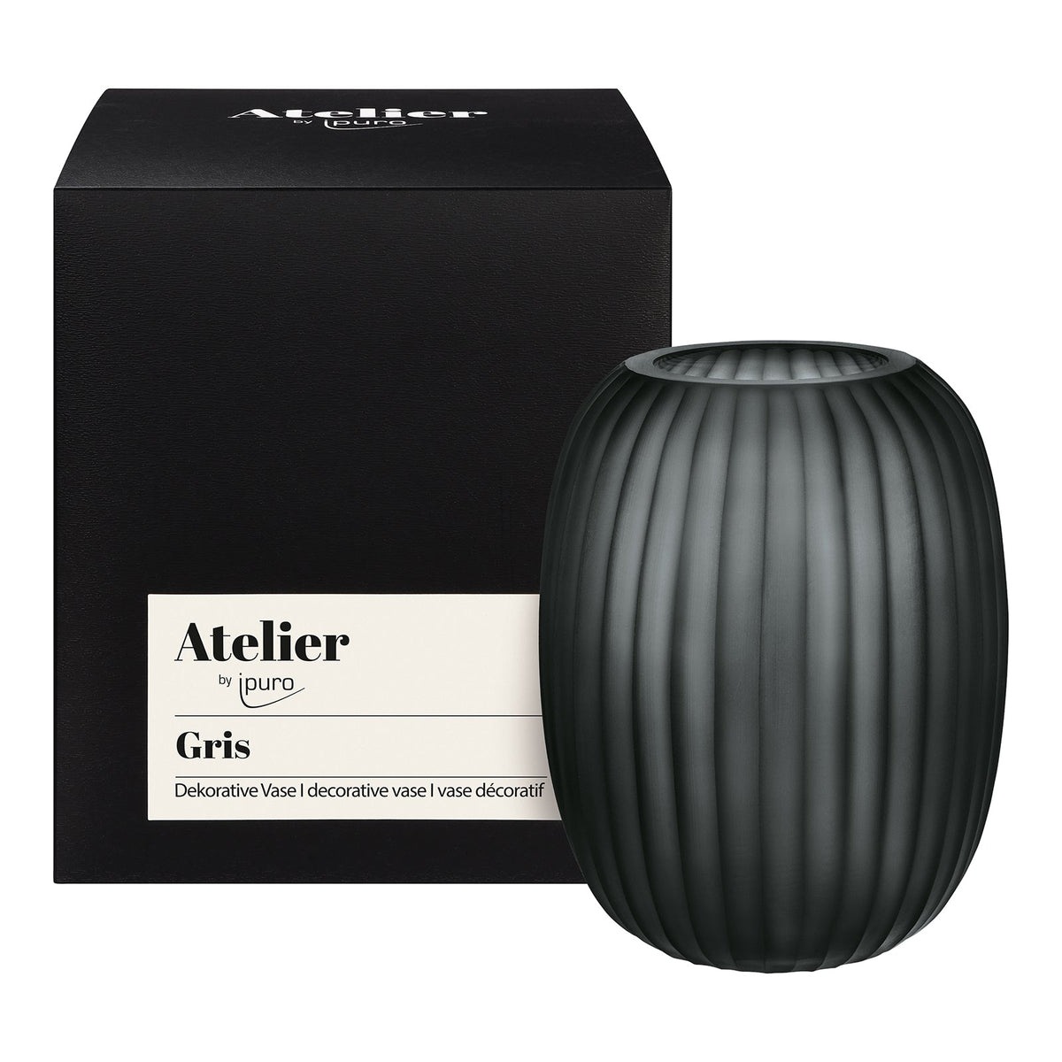 Eine mattschwarze, gerippte Vase aus der Kollektion ipuro Atelier by ipuro gris steht neben ihrer Schachtel mit der Aufschrift Atelier by ipuro gris Vase" in englischer und französischer Sprache und unterstreicht das exklusive Design der Marke.