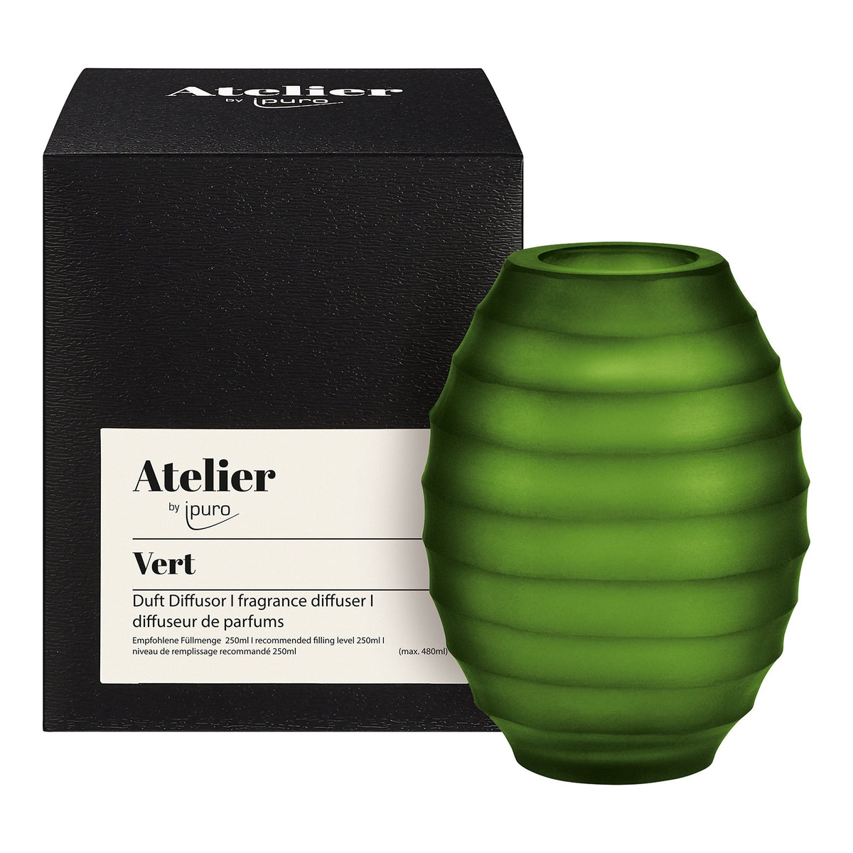 Der grüne, gerippte Glasdiffusor Atelier by ipuro vert von ipuro steht neben seinem schlichten schwarzen Gehäuse und verbindet raffinierten Duft mit elegantem Design für eine stilvolle Note.